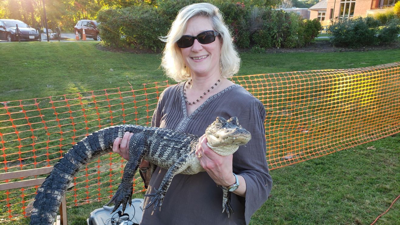 Abby Kingsbury holding a crocodile